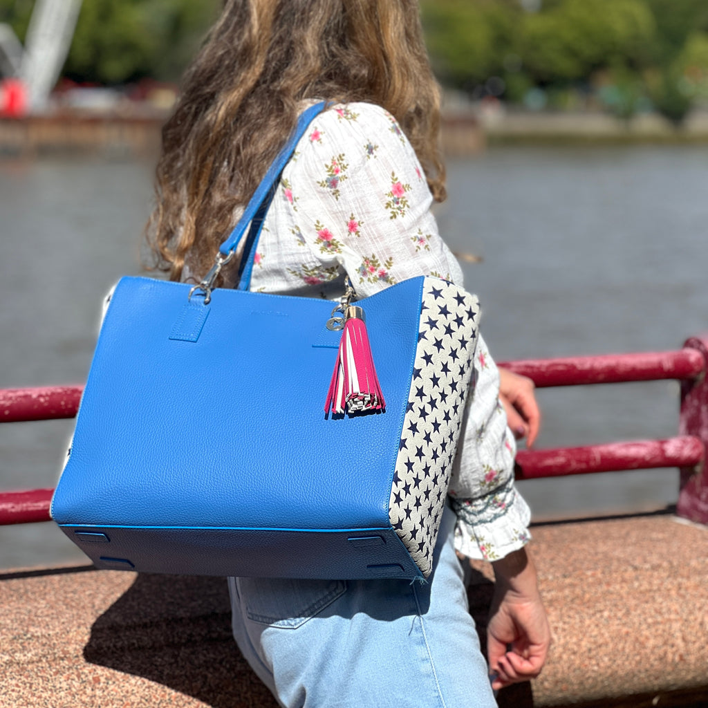 Lady wearing blue leather tote bag and Lipstick/chalk large tassel