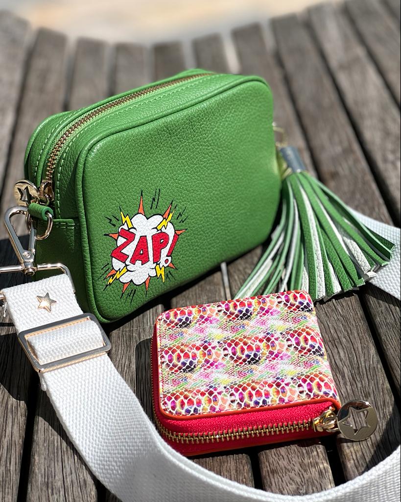 Small Green leather cross body bag with graphic painting phrase 'ZAP' in both left corner with white slim fabric interchangeable strap and green and white remouvable large bag tassel.