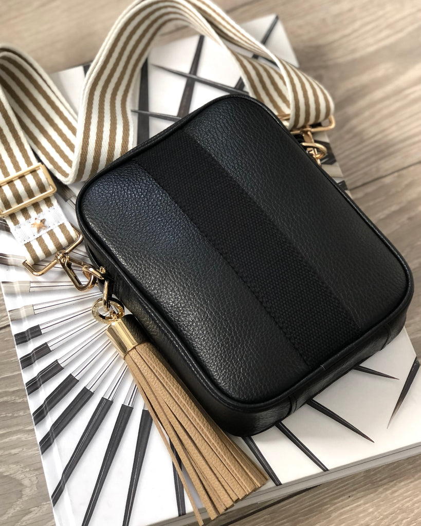 Black camera crossbody bag with interchangeable strap and tassel