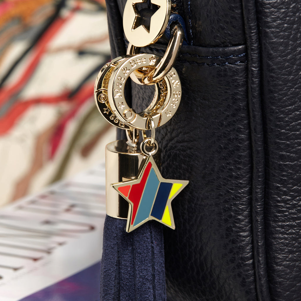 Star key chain with orange, red, blue, navy and yellow on it with attachable charm ring 