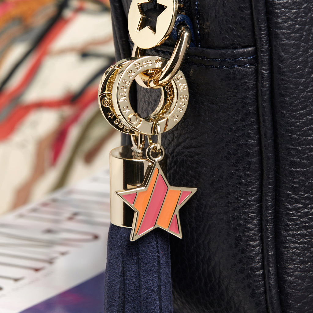 Orange and pink striped star with gold hardware and attachable charm ring 