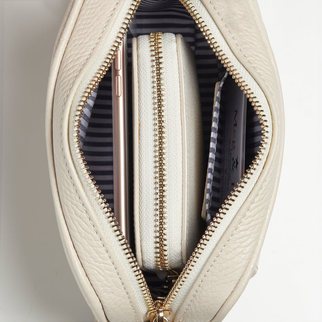 Interior showing blue/white striped lining with purse and phone