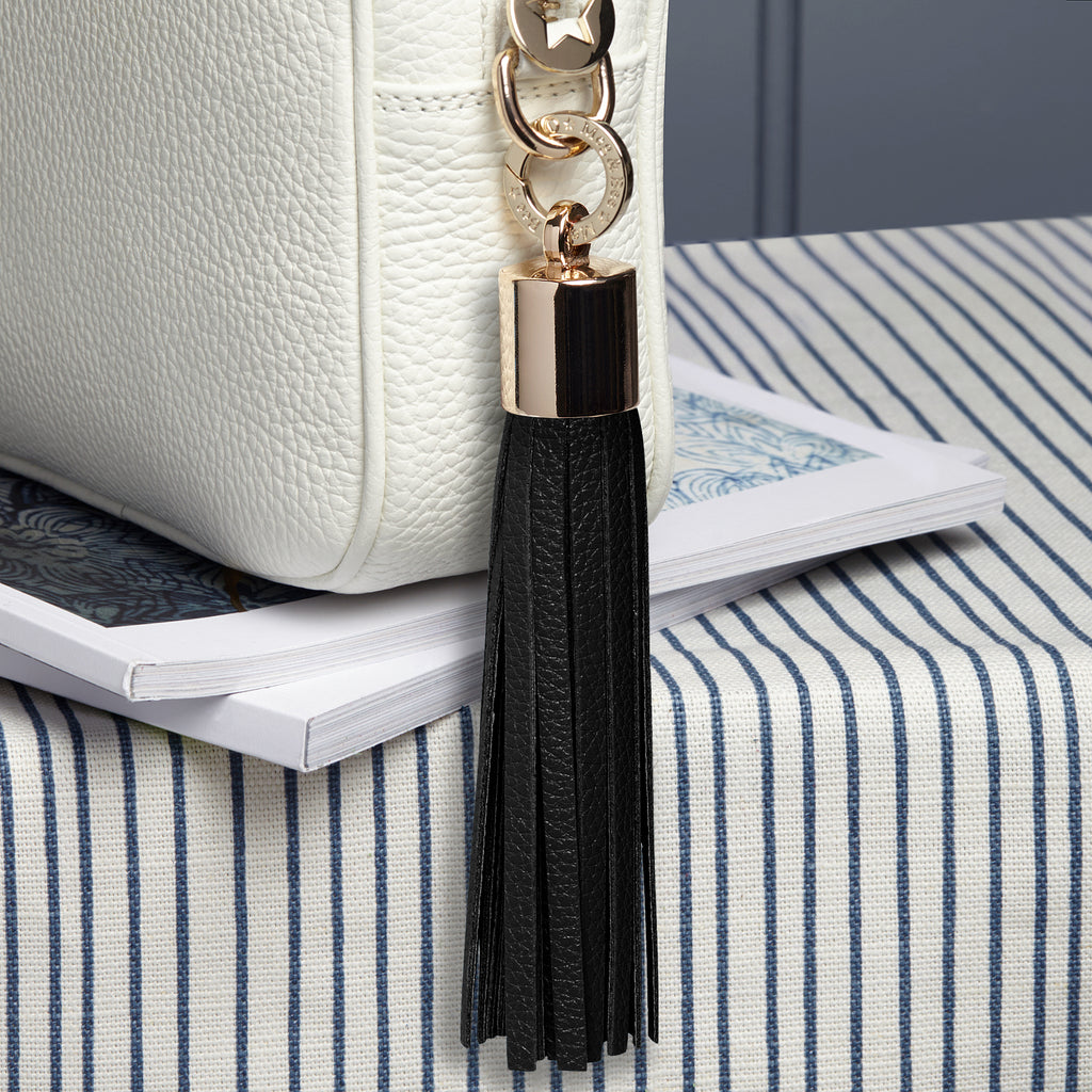 large leather removable bag tassel with gold hardware and attachable charm ring 