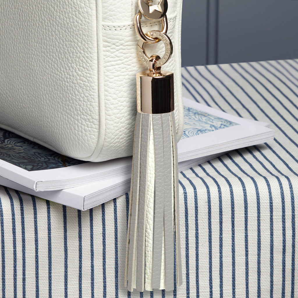 Large leather grey and white removable bag tassel with gold hardware and attachable charm ring 