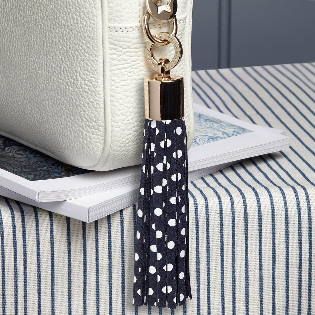 large suede leather navy blue and white dot removable bag tassel with gold hardware and attachable charm ring 