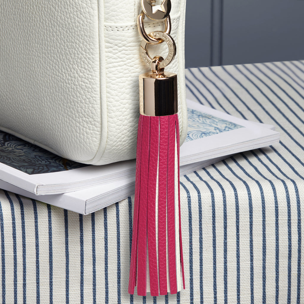 large leather pink and white removable bag tassel with gold hardware and attachable charm ring 