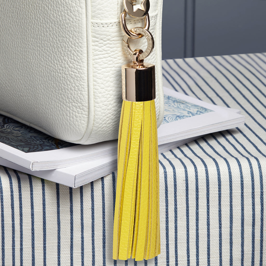 Large leather yellow removable bag tassel with gold hardware and attachable charm ring 