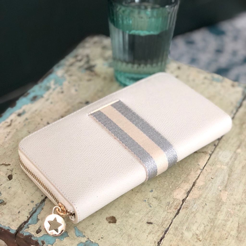 Large rectangular cream leather purse with cream and silver central webbing stripe all with gold hardware
