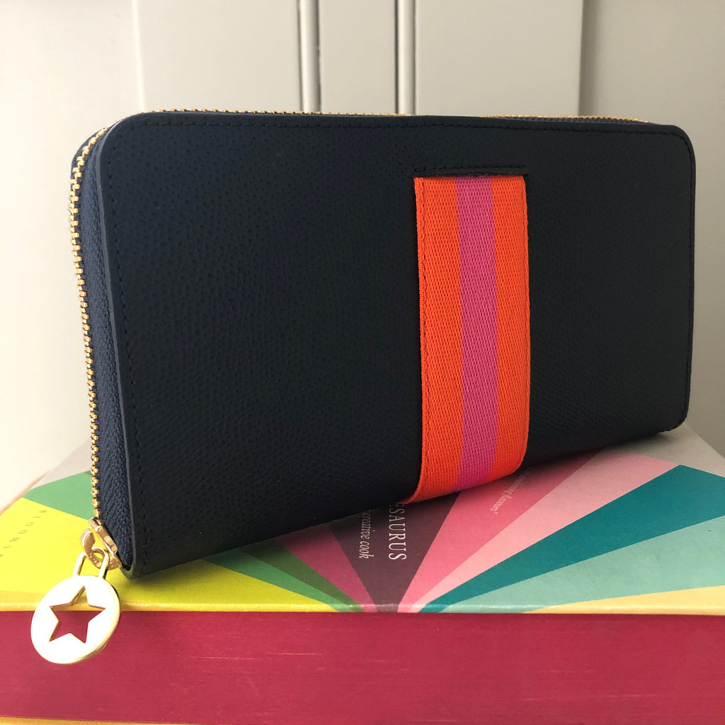 Large rectangular navy blue leather purse with orange and pink central webbing stripe with gold hardware