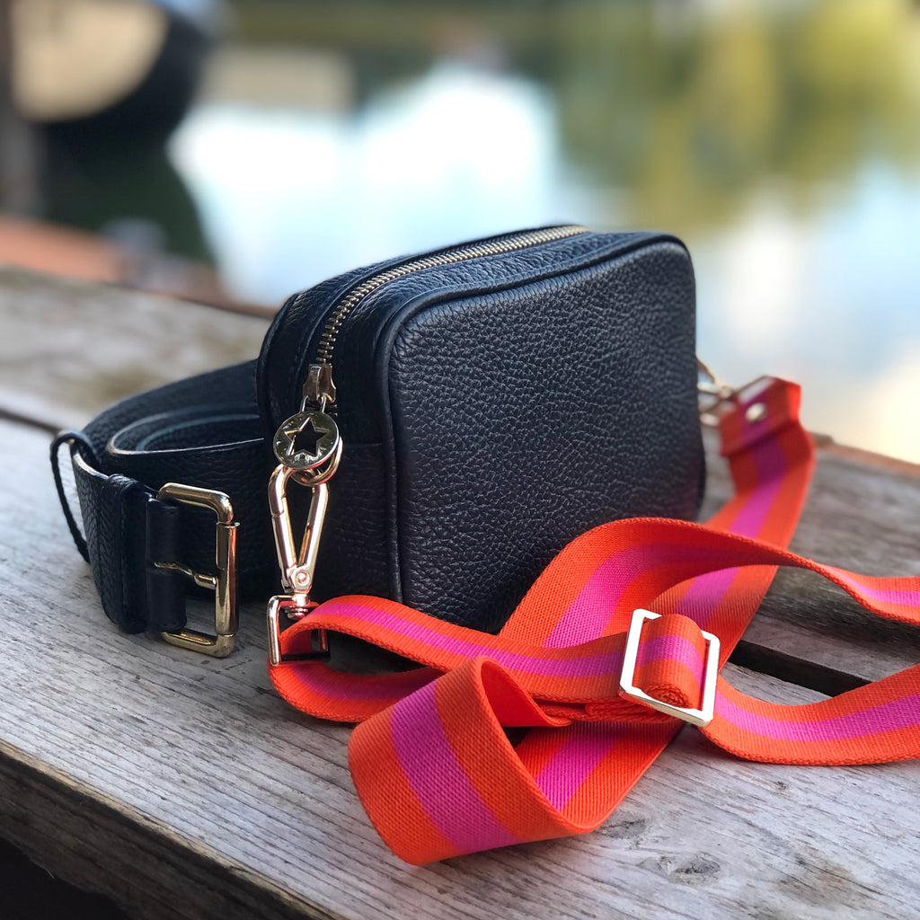 Navy mini and belt crossbody bag with a orange and pink striped fabric strap all with gold hardware 