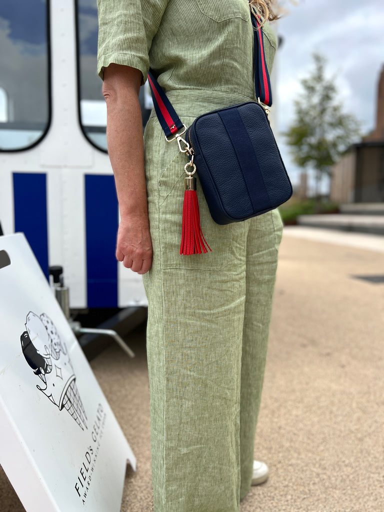 Navy blue camera crossbody bag with interchangeable strap and tassel