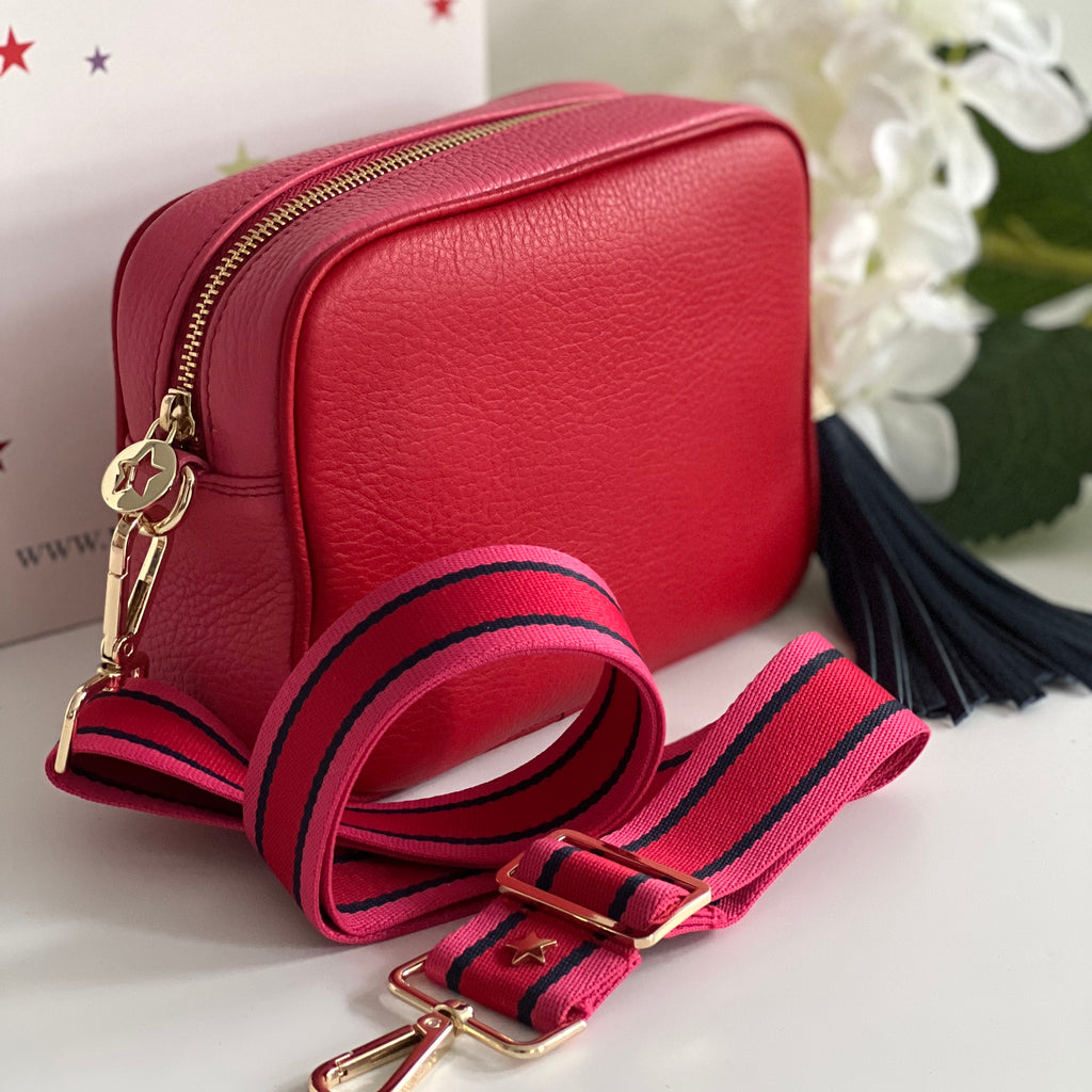 pink and red camera bag with navy large bag tassel and pink, red and navy fabric strap all with gold hardware 