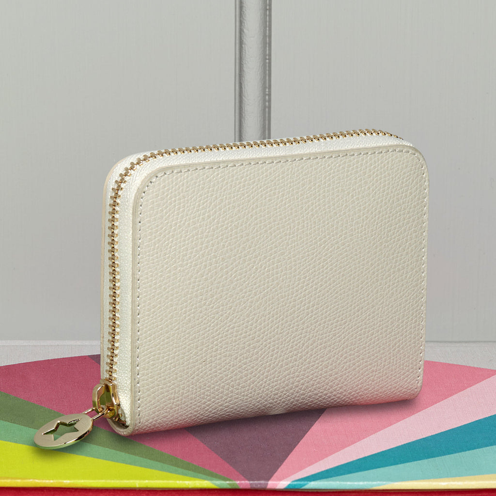 Small cream leather purse with gold hardware.