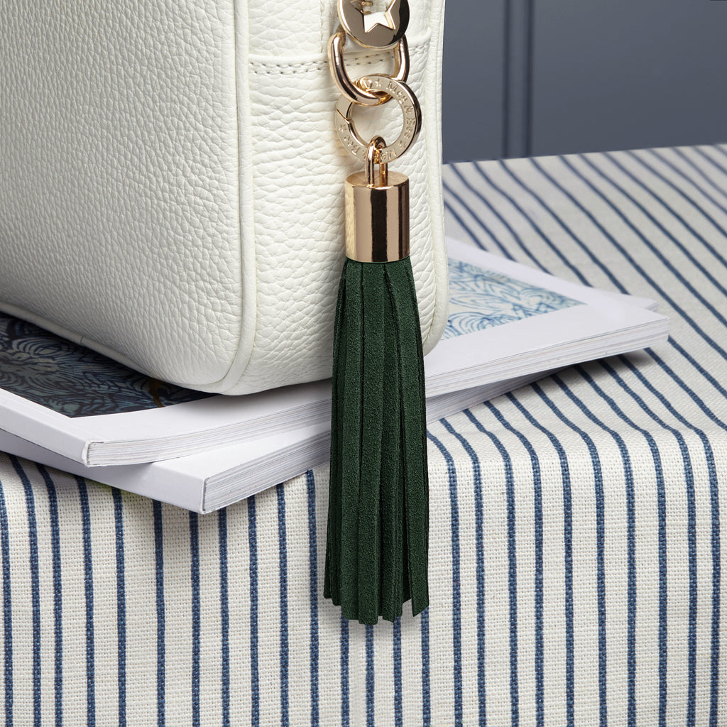 small leather dark green removable bag tassel with gold hardware and attachable charm ring 