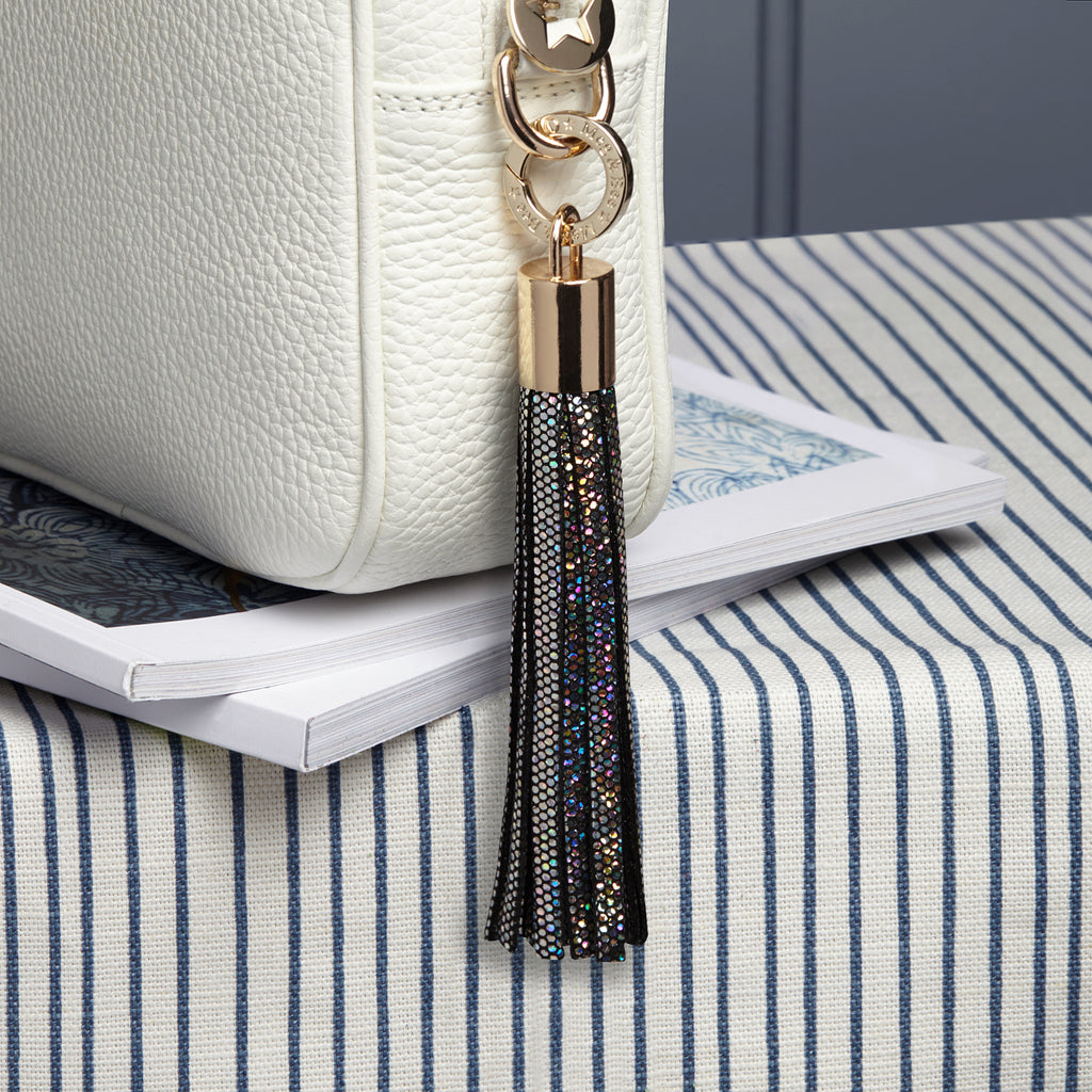 Small leather disco pattern removable bag tassel with gold hardware and attachable charm ring 