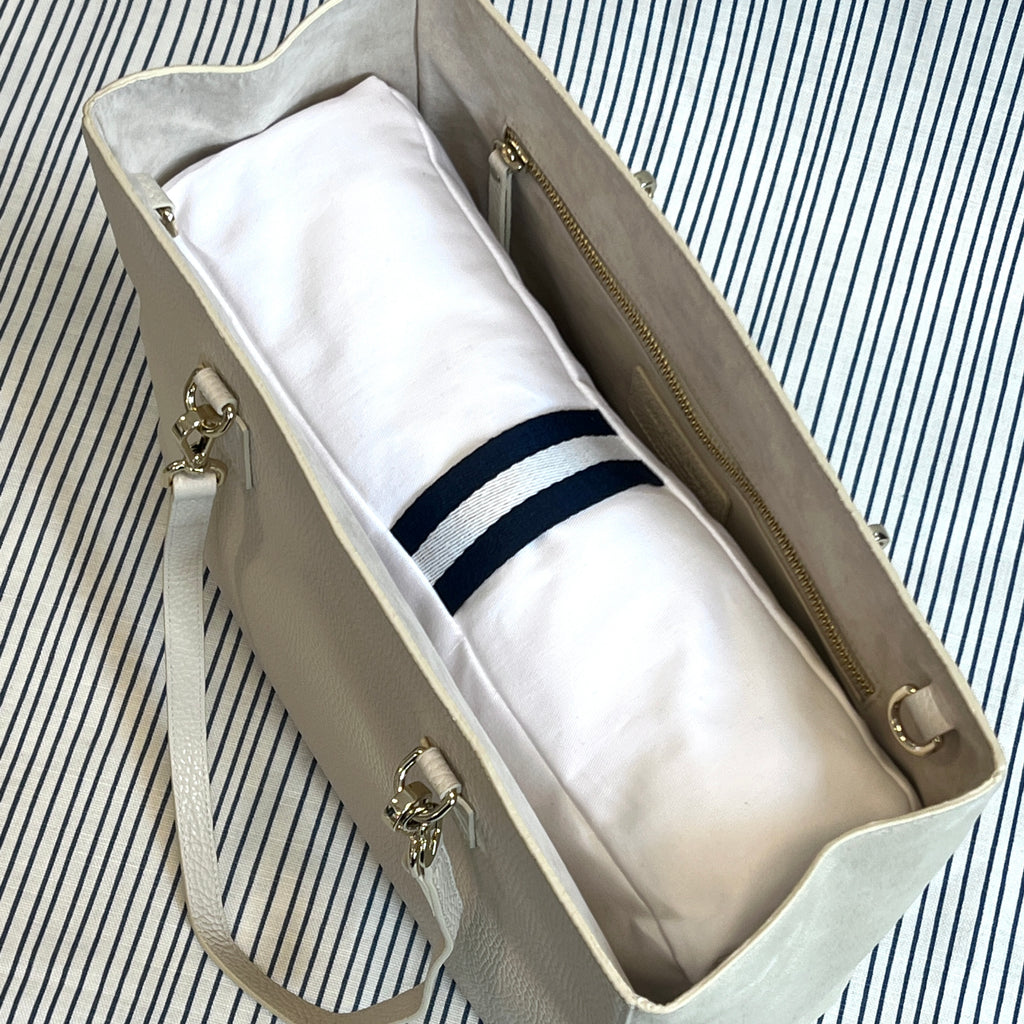 White bag pillow with navy/white carry handle