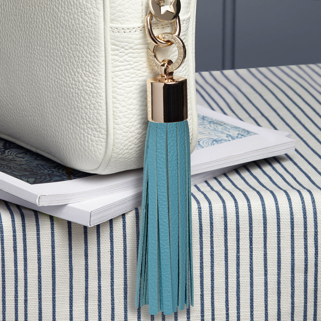large leather aqua blue removable bag tassel with gold hardware and attachable charm ring 