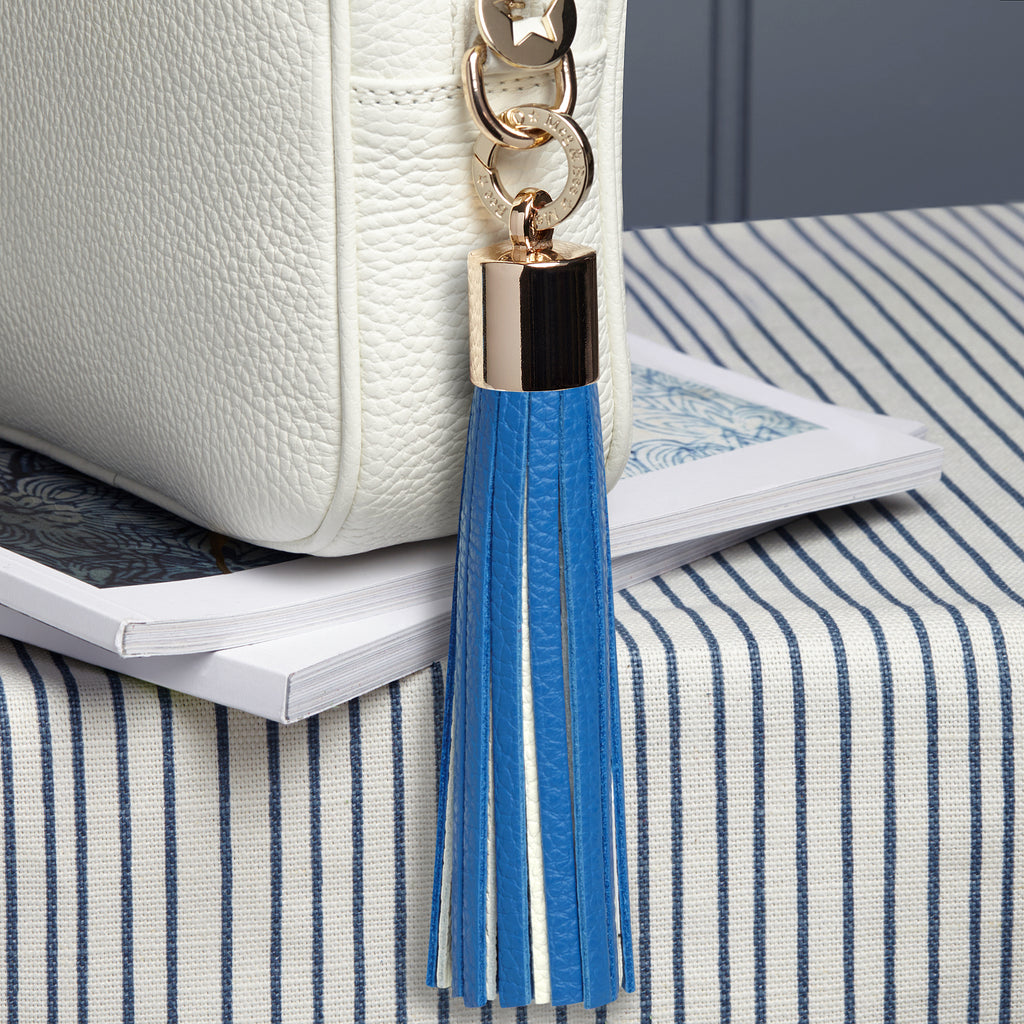 large leather blue and white removable bag tassel with gold hardware and attachable charm ring 