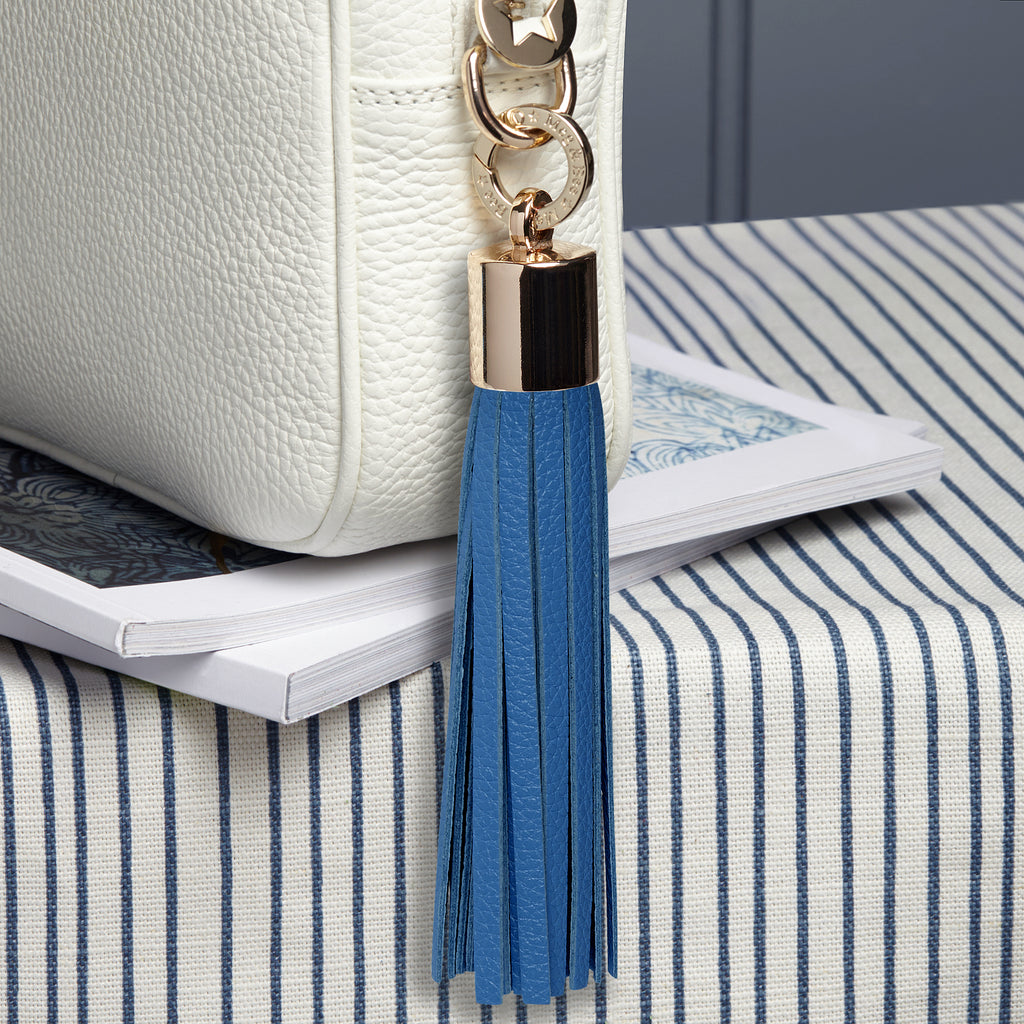 large leather light blue removable bag tassel with gold hardware and attachable charm ring 