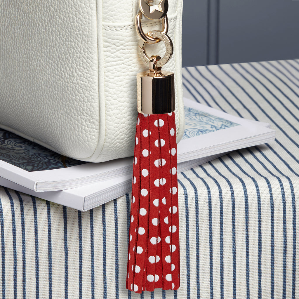 large suede red with white dots removable bag tassel with gold hardware and attachable charm ring 