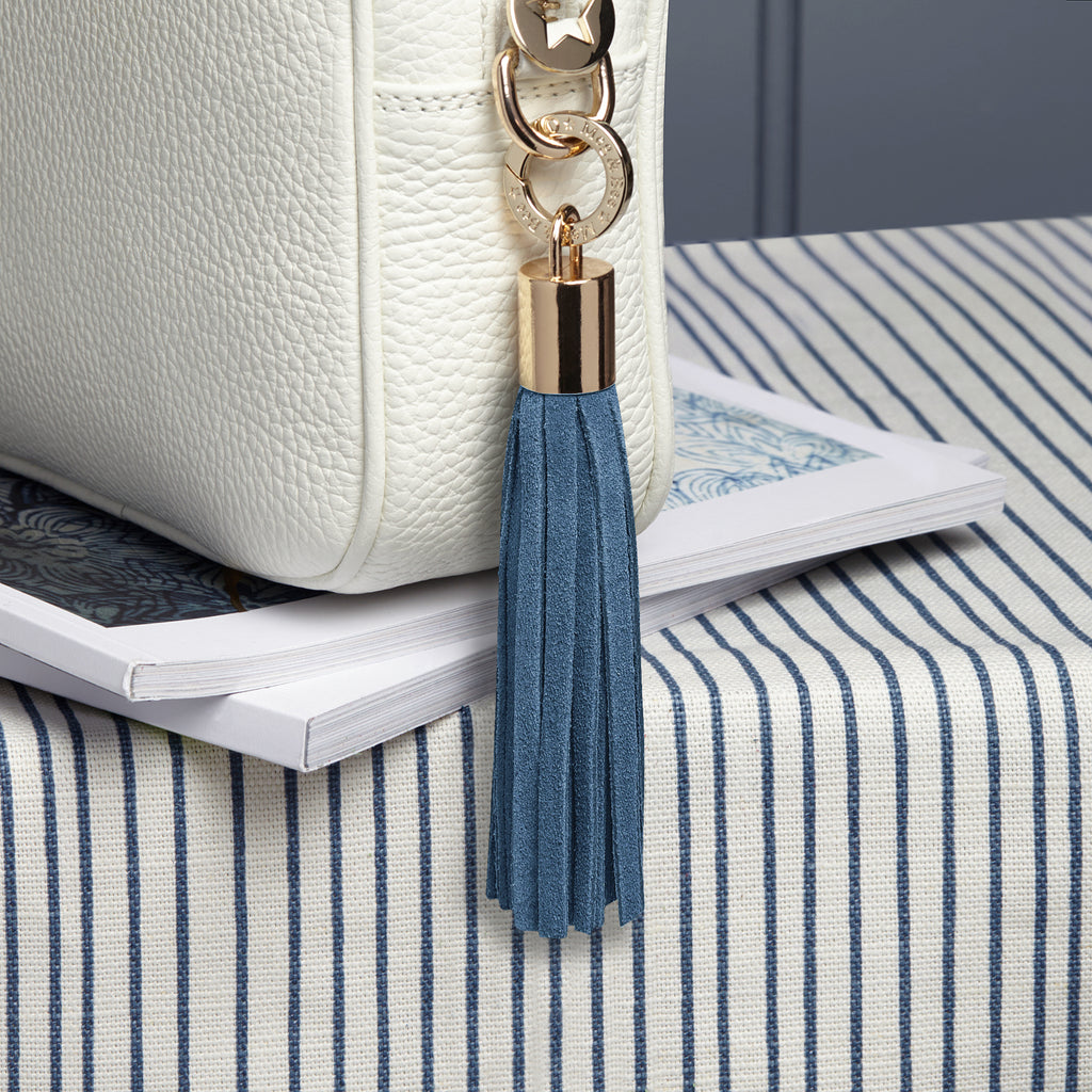 small suede denim blue removable bag tassel with gold hardware and charm ring 