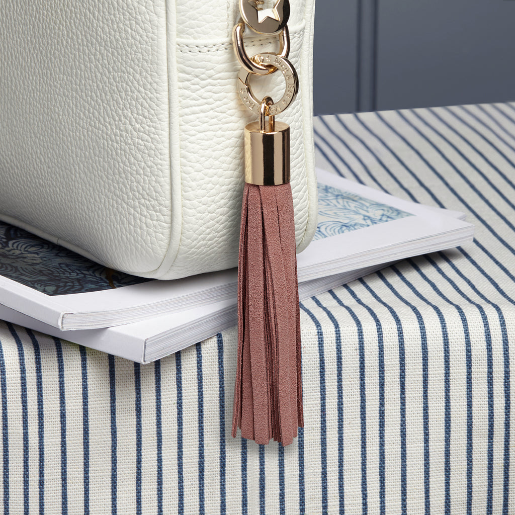 small suede light pink removable tassel with gold hardware and charm ring 