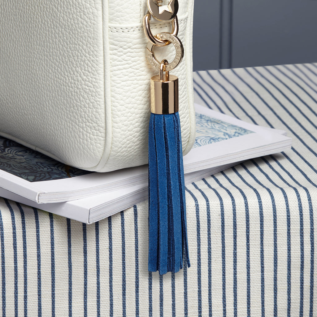 small suede sky blue removable bag tassel with gold hardware and charm ring 